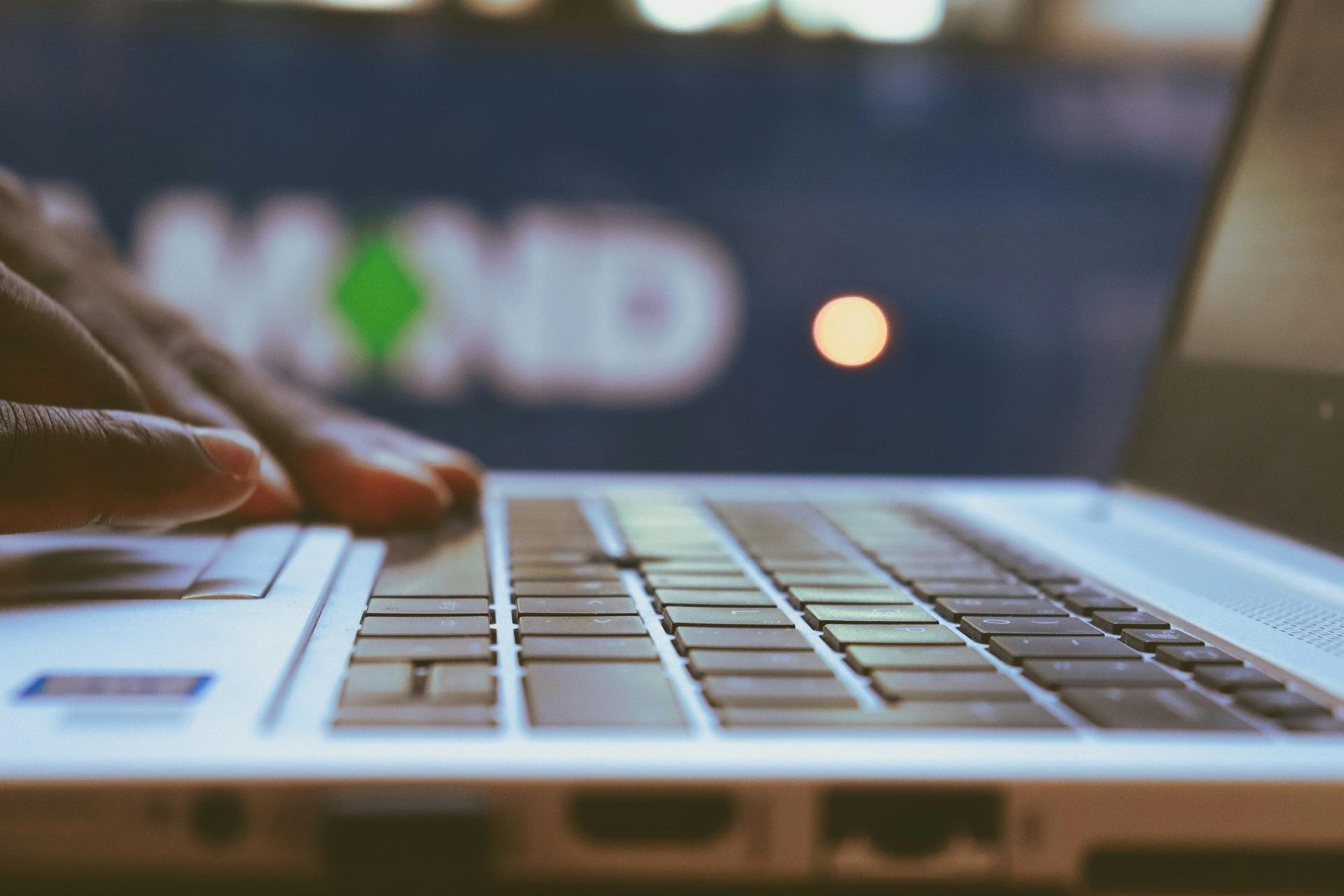 Person Working on Laptop - LLM Performance Metrics